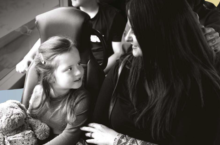 A mother and child travelling on the bus together
